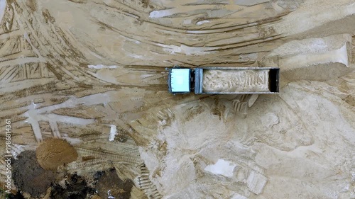 Truck unloading sand top view. A huge Thunar truck brought sand to the quarry. High quality 4k footage