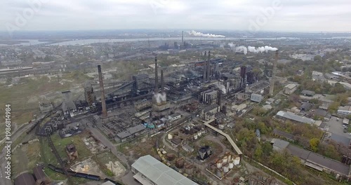 Aerial View of Aging Refinery With River and City on Horizon