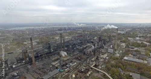 Aerial Industrial Complex Emitting Smoke Near Residential Area