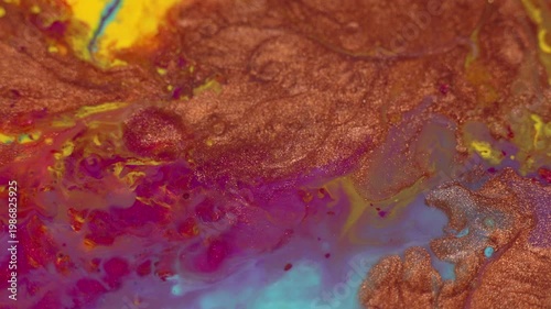 Colorful abstract fluid art background, acrylic paint macro detail. Shiny copper, pink, blue and yellow patterns. Anti-stress videos