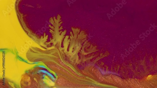 Abstract fluid acrylic paint macro background with vibrant gold, yellow, pink colors