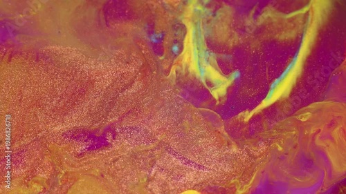 Macro shot of liquid acrylic paint texture with cells and color gold, yellow, pink mixing