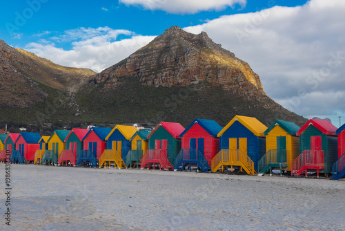 The iconic colorful beach at Muizenberg Beach, located near Cape Town on False Bay, is world-famous for its iconic huts, excellent and safe surfing conditions for beginners, and warmer water. It is th
