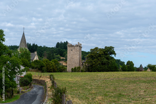 Empty ancient village with a square medieval tower in the background, Aveyron, France