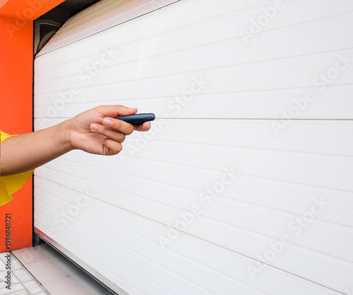 Garage door PVC. Hand use remote controller for closing and opening garage door
