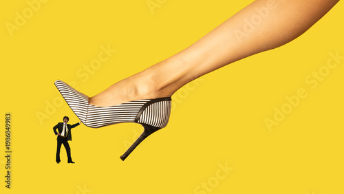 Fotografie Tiny businessman pushing giant high heel shoe