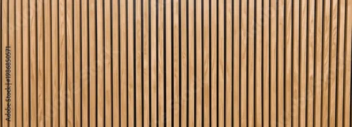 Panel kuchenny z motywem Vertical wooden slats forming a textured wall panel in varying shades of natural brown.