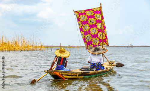 Fishermen in a small boat at lake Nokoué in Benin, West-Africa