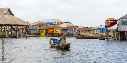 Fishermen in a small boat at lake Nokoué in Benin, West-Africa
