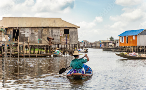 Fishermen in a small boat at lake Nokoué in Benin, West-Africa
