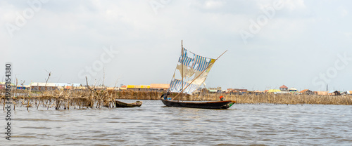 Fishermen in a small boat at lake Nokoué in Benin, West-Africa