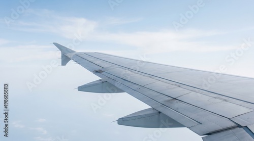 Airplane wing view from window above clouds travel journey concept