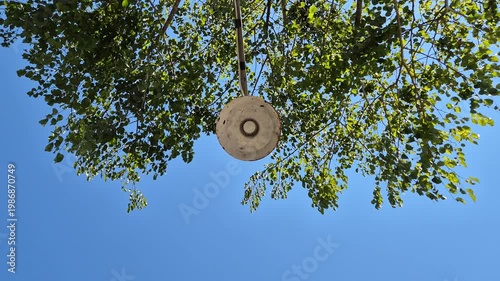 Low Angle Shot of Vintage Street Lamp Under Green Tree Leaves and Clear Blue Sky