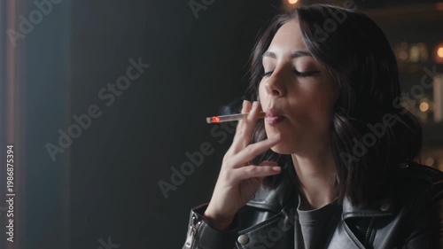 Moody portrait of a stylish woman smoking a cigarette at night, capturing a contemplative and cinematic moment in an urban setting.