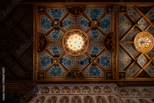 Tableau sur toile Gilded ceiling and chandelier light at Castle De Haar interior