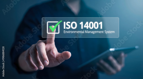 Businessman touching iso 14001 environmental management system certification icon on virtual screen