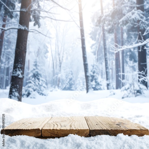 A wooden platform in a snowy forest with trees and sunlight