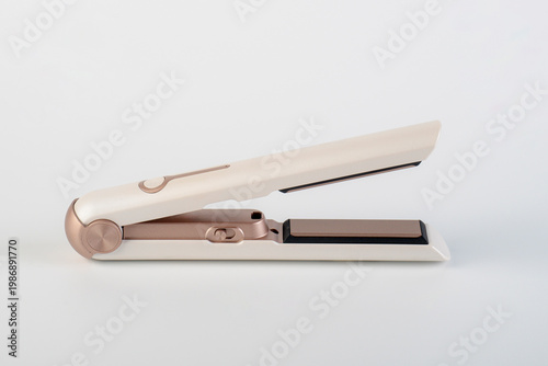 Εκτύπωση καμβά A white cordless hair straightener on white background.
