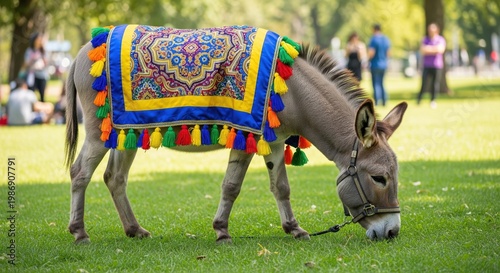 A donkey grazes on green grass, adorned with colorful patterned blanket. A whimsical portrait of nature and culture. Playful animal, vibrant colors, summer day.