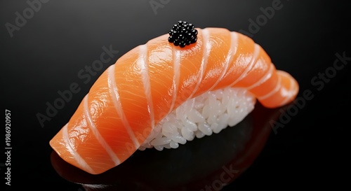 Salmon nigiri sushi topped with black caviar on dark background studio close up.