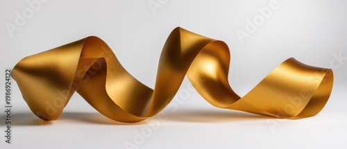A lustrous golden ribbon, gracefully swirling against a clean white backdrop, capturing light with smooth folds and elegant curves