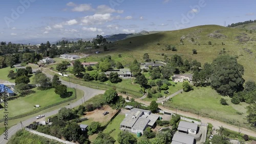 Drone flies over neighborhood on hill in the early afternoon in mountain town of Mbabane, Eswatini