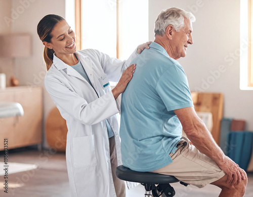 Smiling brunette doctor performs a thorough back examination on an elderly male patient in a sunny clinic. Ideal for geriatric care, rehabilitation, and compassionate medical themes.