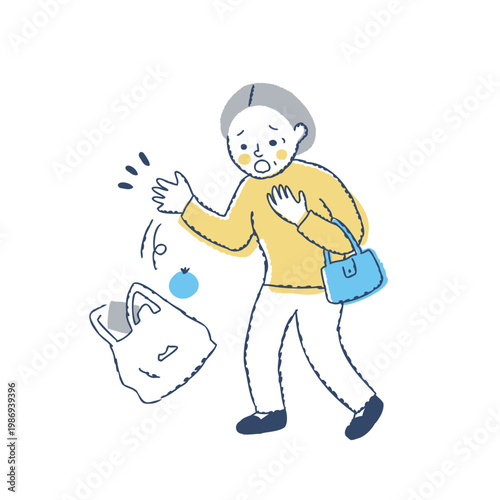 手から買い物袋が落ちて慌てるシニア女性