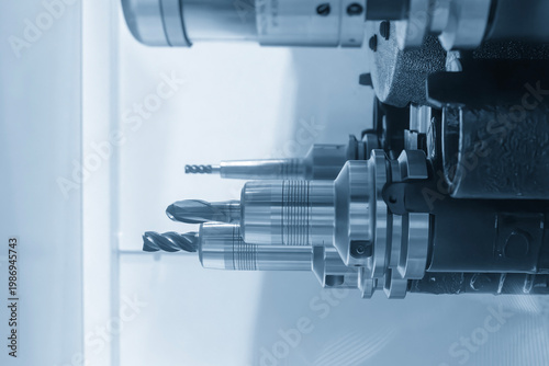Close-up of a ball nose end mill tool with holder installed in a CNC milling machine tool magazine.