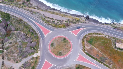 Aerial view of a roundabout at a ocean with cars in Spain (Andalusia)
