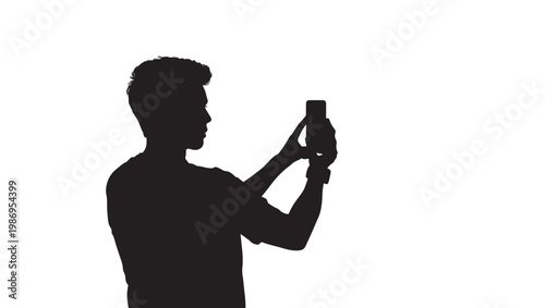 Silhouette of a young man holding a smartphone vertically to take a photo or record a video