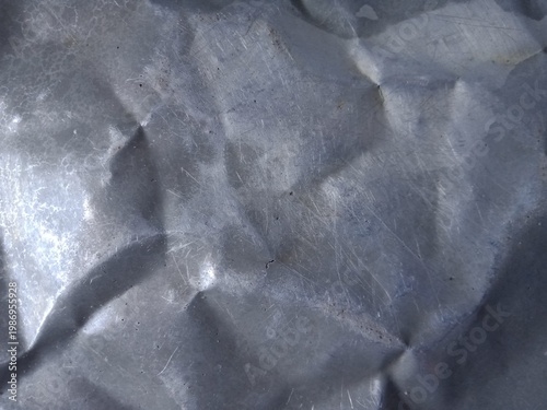Fotografie Close up photo of Dented Aluminium Plate as a grunge background.