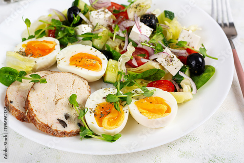 Mediterranean Salad with Feta Olives and Eggs on white plate