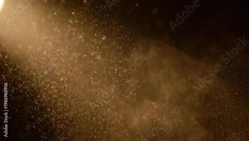Dust particles illuminated by a beam of light in the dark.