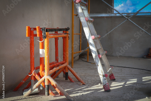Construction site with scaffolding, ladder, and sawhorse, ready for building work