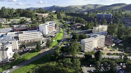 Drone flies south out of the city along Mhlambanyatsi Road in the late afternoon before sunset in mountain town of Mbabane, Eswatini