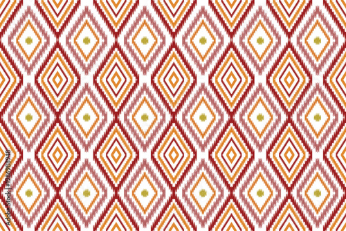 A vibrant Ikat textile motif featuring a repetitive grid of nested diamond shapes. The design utilizes a warm color palette of red, orange, and golden yellow against a crisp white background.