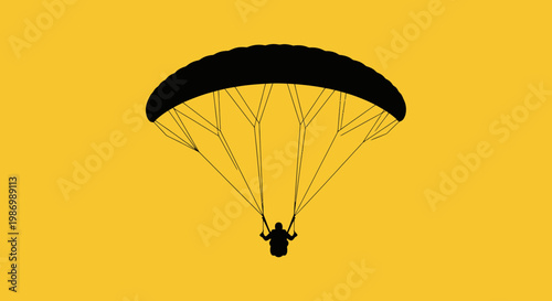 Paraglider Silhouette Against Bright Yellow Sky