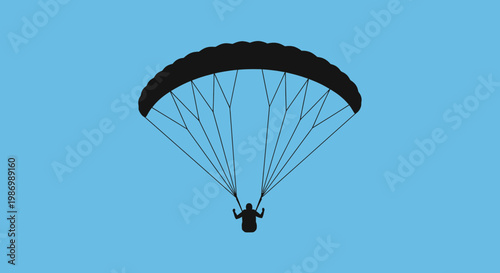 Paraglider Silhouette Descending Gracefully Against A Clear Blue Sky