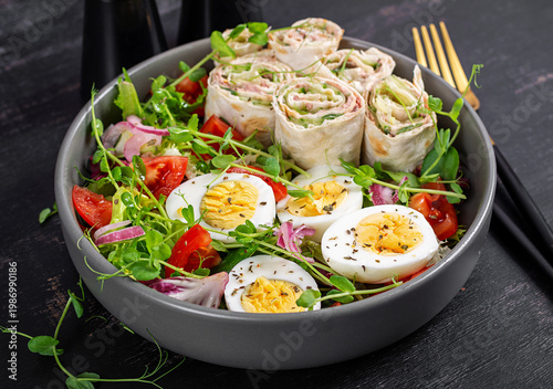 Keto diet meal with tuna lavash rolls salad and boiled eggs.