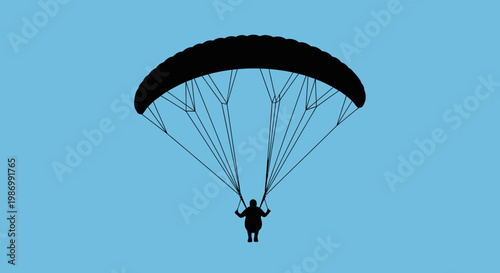 Paragliding Silhouette Against A Clear Blue Sky