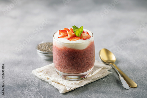 Chia pudding on coconut milk with strawberries and yogurt in a glass. Healthy eating