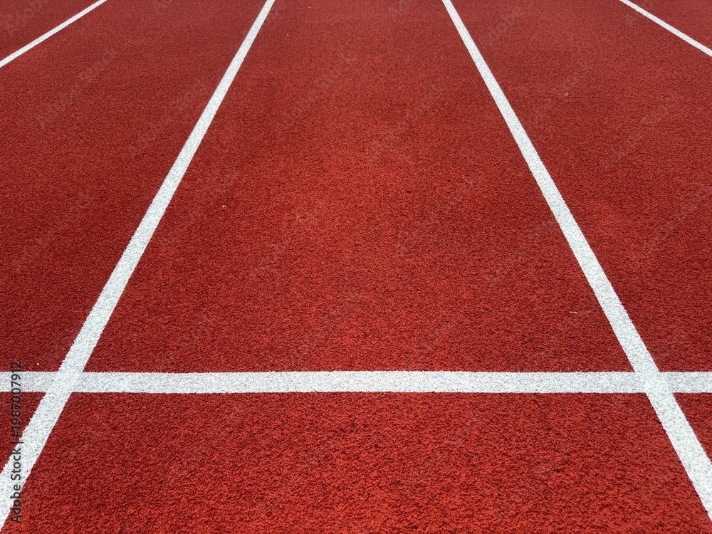 Fototapeta premium red running track with white lane lines background