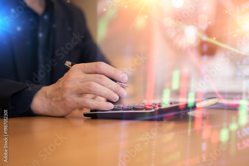 Quadro su tela Close-up of a businessman using a calculator with financial data and stock market graph overlay, representing business analysis, investment planning, and financial growth