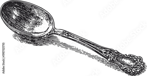 Vintage ornate silver spoon with intricate floral design isolated on white background