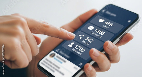 Person holding a smartphone displaying social media engagement metrics and a smartwatch.