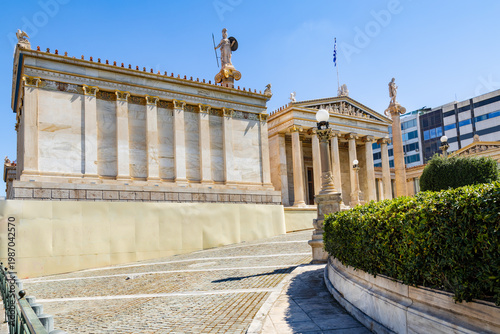 The neoclassical building of the modern Academy of Athens. Statues of Athena and Apollo stand atop the columns. Athens, Panepistimio, Greece