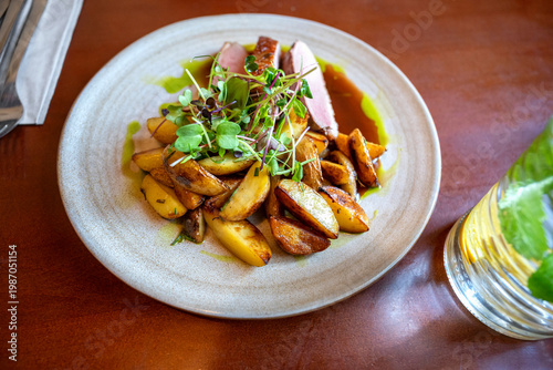 Wallpaper Mural Sliced duck breast fillet with baked potato and green herb in spicy sauce. Torontodigital.ca