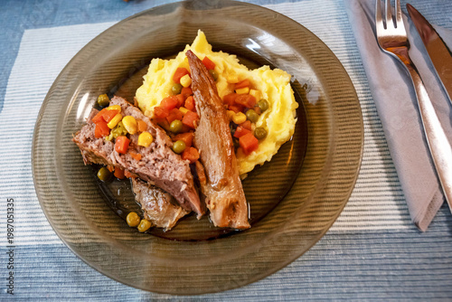 Wallpaper Mural  Baked pork meat on mashed potato, vegetable and cutlery on table. Torontodigital.ca