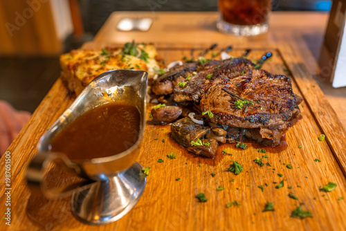 Wallpaper Mural Grilled pork meat, sauce in sauce boat, easter stuffing on wooden board. Torontodigital.ca